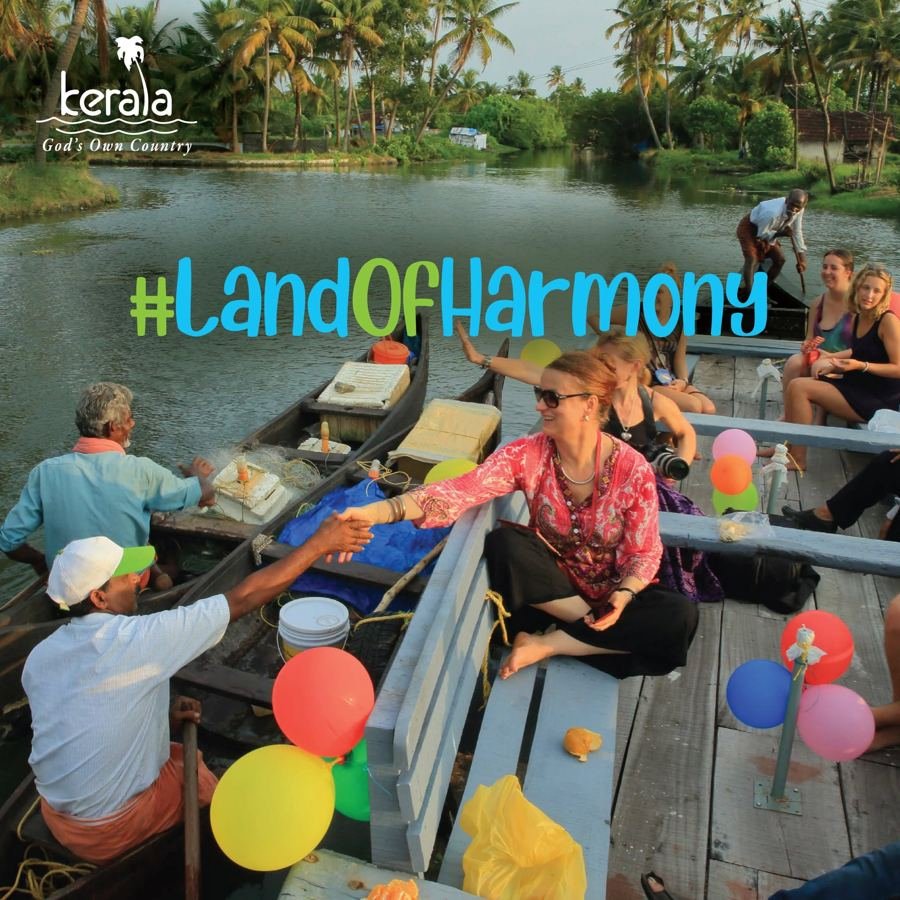 #LandOfHarmony post: travellers shaking hands with boatmen on the Kerala backwaters